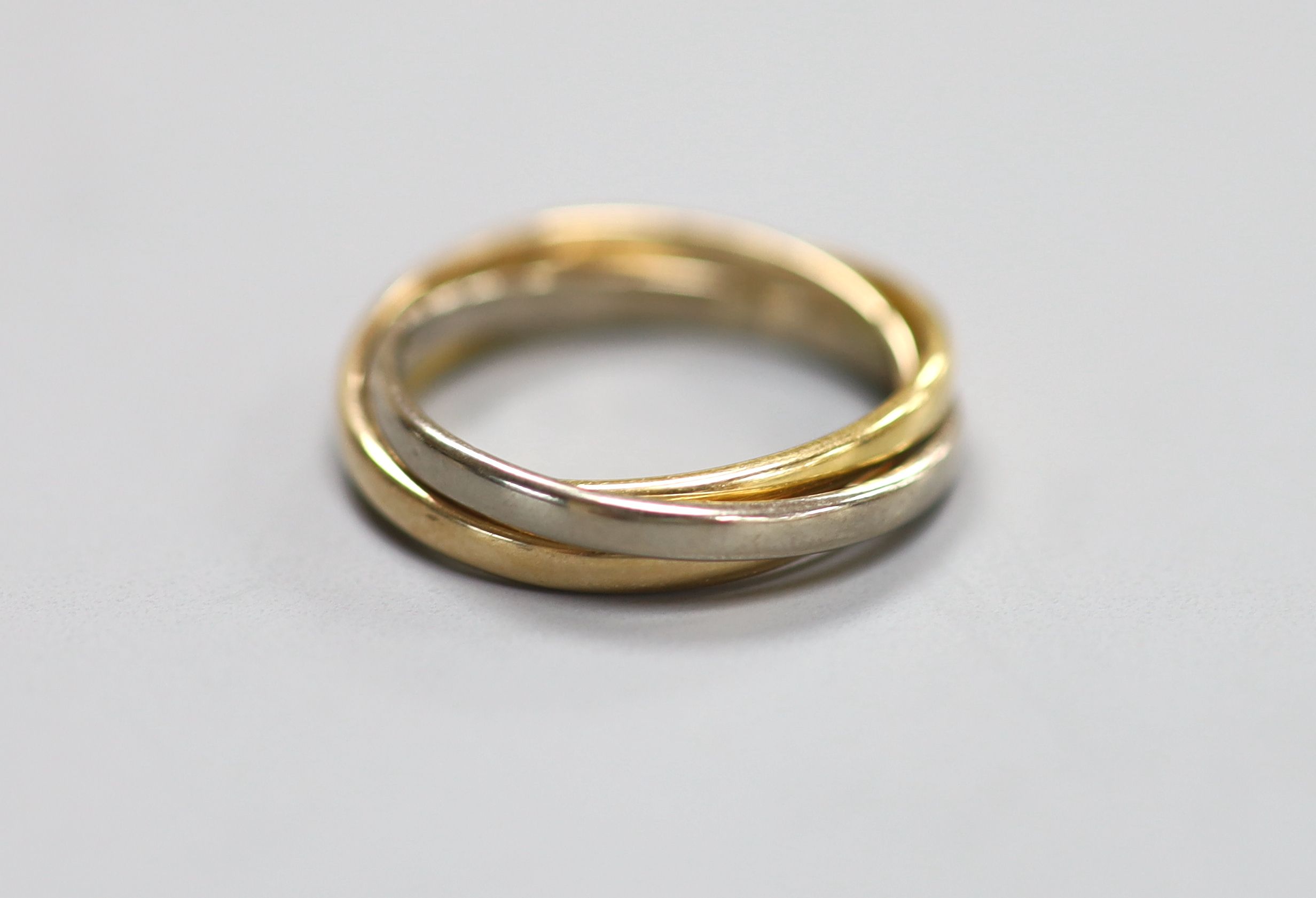 A modern three colour 18ct gold 'Russian' triple band wedding ring, size O